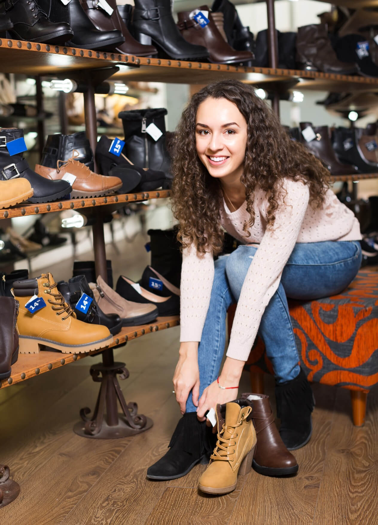 A smiling woman trying on shoes