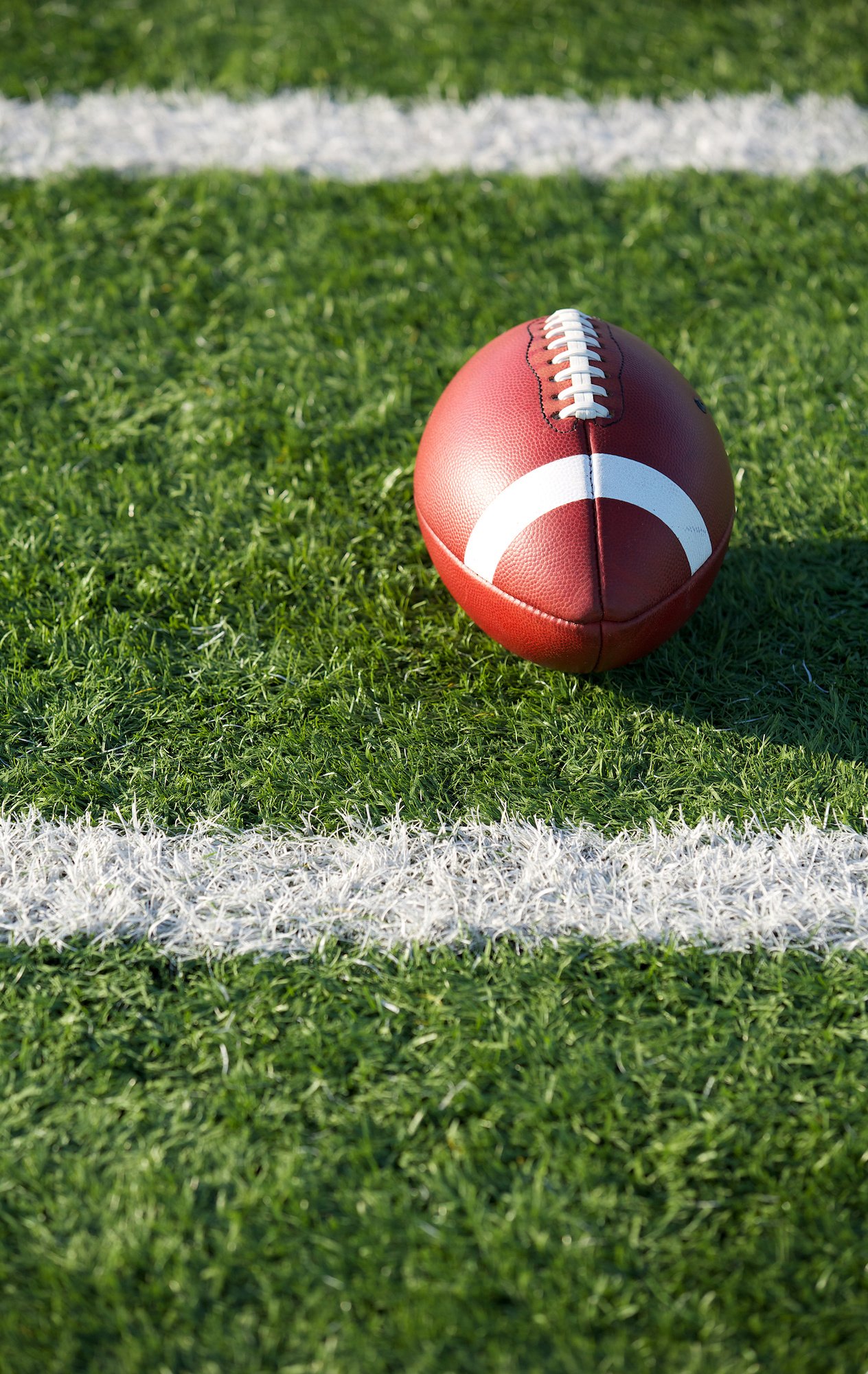 american football on a field in between lines